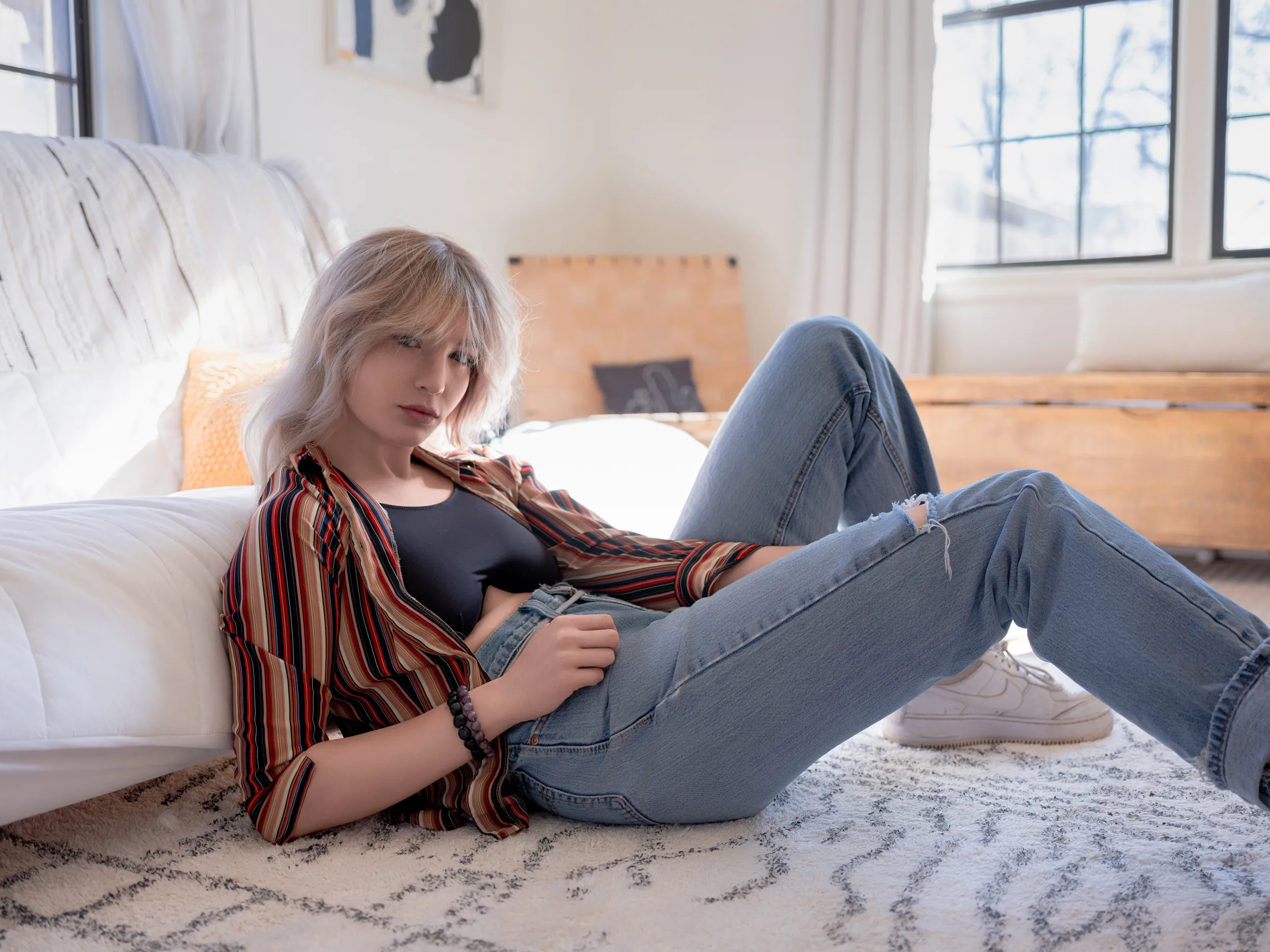 Relaxed environmental portrait reclining in a bright interior